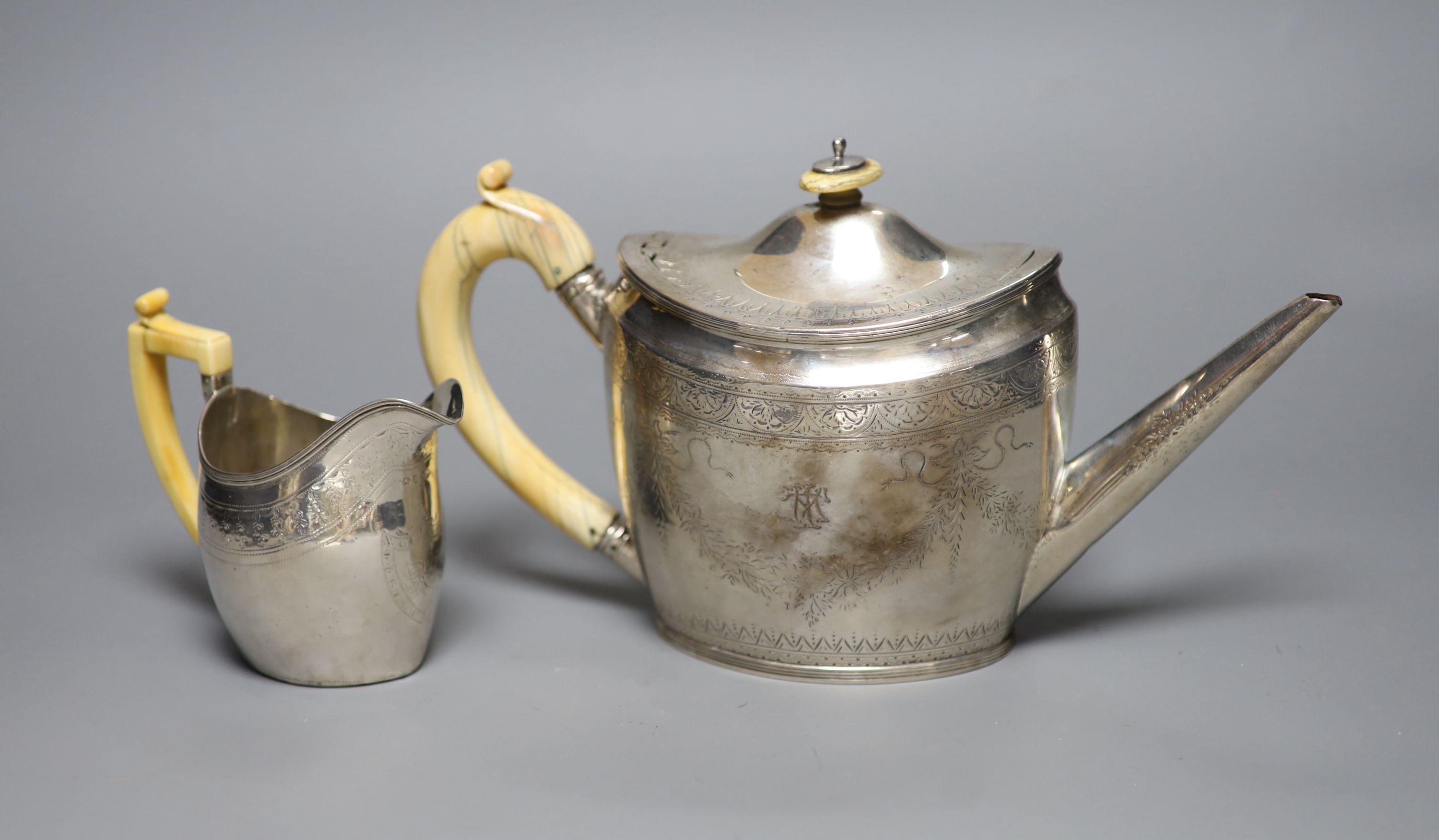 A George III silver teapot, with ivory handle, Henry Green, London, 1795 and a similar cream jug, London, 1796, (a.f.)